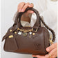 011599 — Brown mini charm barrel handbag detail, 14 × 20 × 10 (Brown)