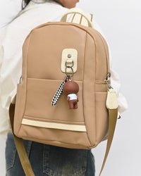 013685 — Beige bear-charm backpack front, 32 × 28 × 12 (Beige)