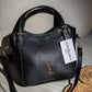 AD1017 — Black buckle-handle handbag front, 23 × 20 (Black)