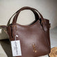 AD1017 — Brown buckle-handle handbag front, 23 × 20 (Brown)