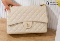 BM125 — Ivory quilted chain shoulder bag front, 34 × 24 (Ivory)